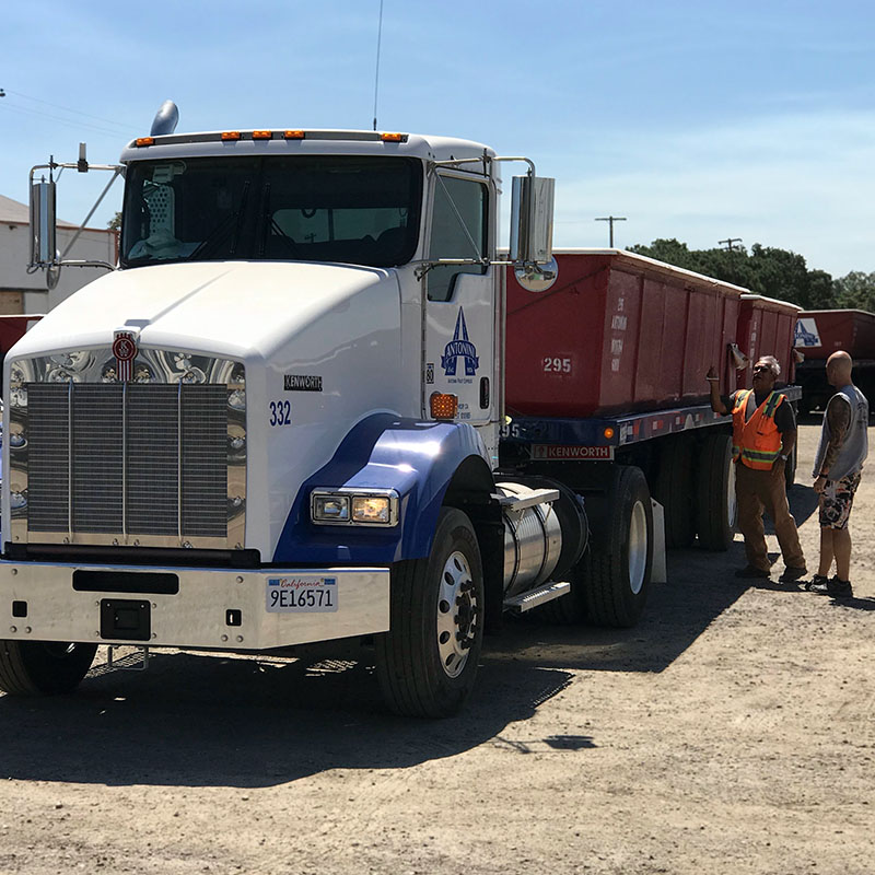 photo of truck driver and safety manager standing next to tomato truck in Modesto, CA